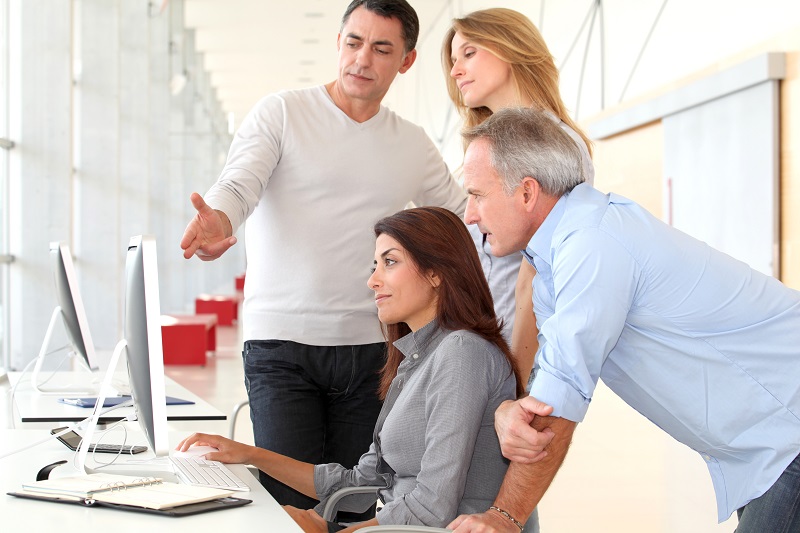 staff sitting at a computer training on web accessibility