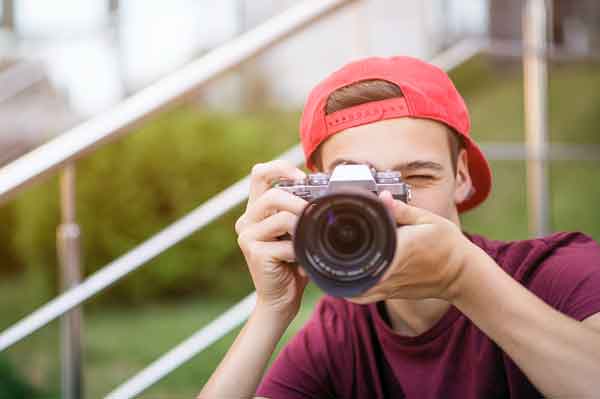 Young man taking pictures for school website