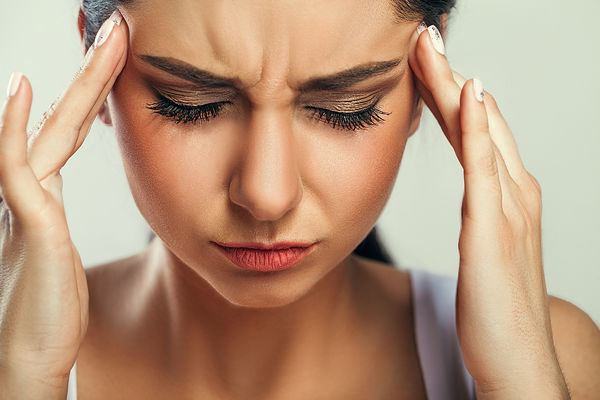 Woman holding head due to stress