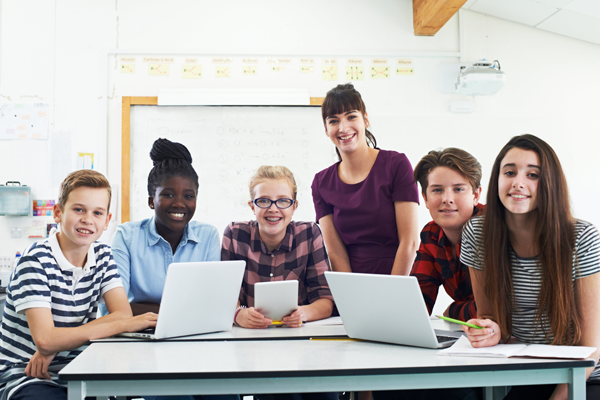 Students looking at laptops and tablets
