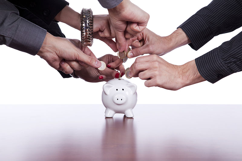 school administrators saving money in a piggy bank