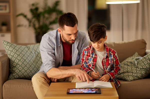 Father helping son with homework.
