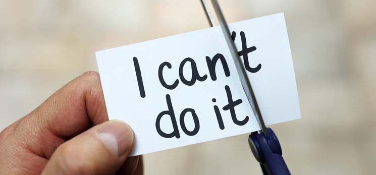 hands with scissors cutting paper so it says I can do it instead of I can't do it