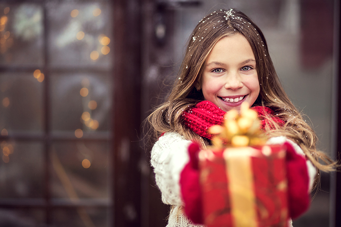 girl giving a Christmas gift