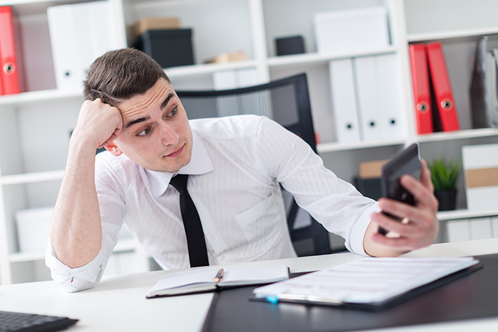 employee looking at calculator worried about accessibility budget