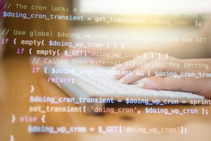 computer code on screen overlaying keyboard