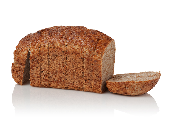 person holding freshly baked whole grain bread