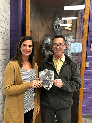 Randy Behne with the KNIGHT ARMOR award at the North Cedar School Board meeting
