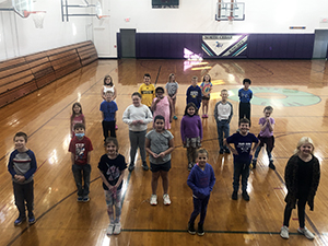 Students proudly social distancing for a fun picture to celebrate their classroom of the week
