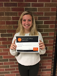 Kealy Taylor holds up her certificate for passing the Microsoft Office 2016 Word Specialist exam
