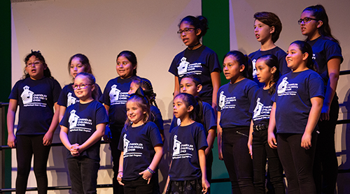 Group of children singing on stage