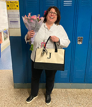 Jessica Margiotta holding flowers and gifts for receiving Teacher of the Year