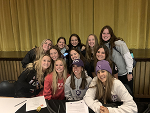 Group of happy female student at signing event