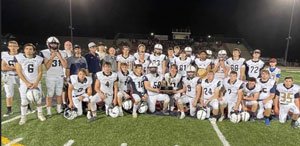Football team posing for a picture on the football field