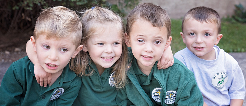 Four young students pose together