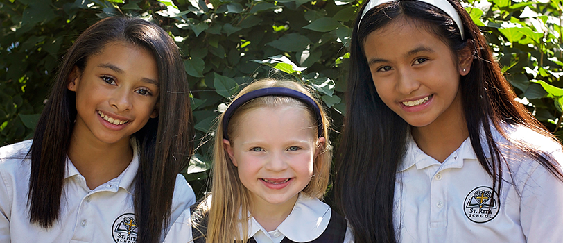 Three smiling female students pose together
