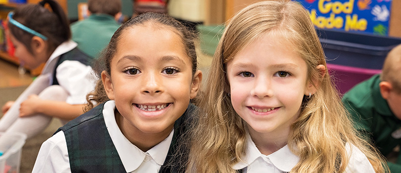 Two smiling female students pose together