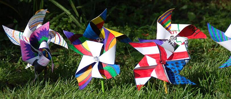 Craft windmills stuck in the grass