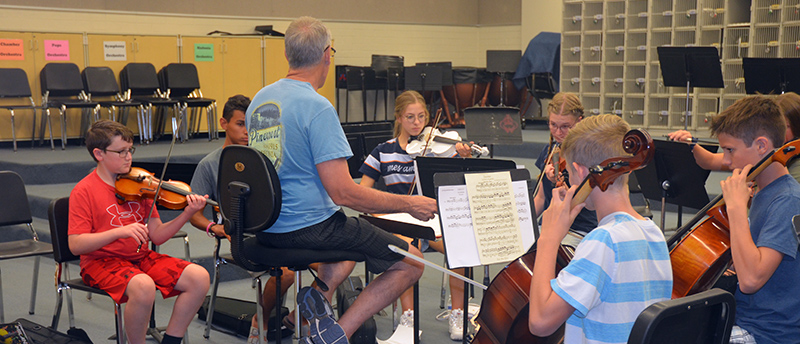 Teacher working with summer academy students in classroom