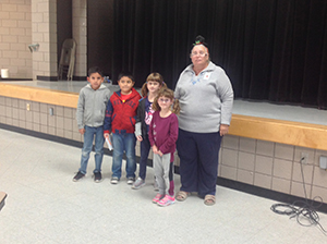 Student stand with their teacher