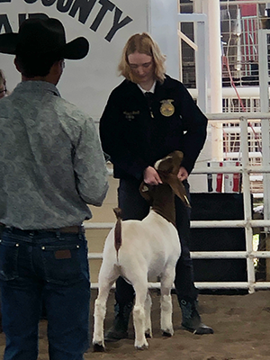 student with her goat at the fair