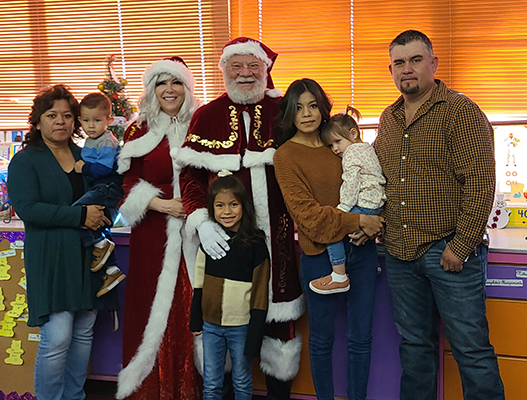 Santa Claus and Mrs. Claus with a family