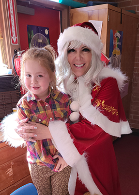 Mrs. Claus with young girl