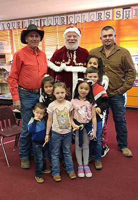 Santa Claus with board members and students