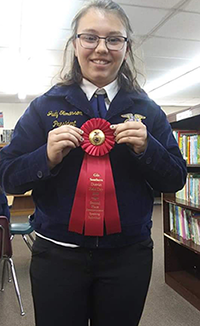 Judy Tumlinson poses with her ribbon