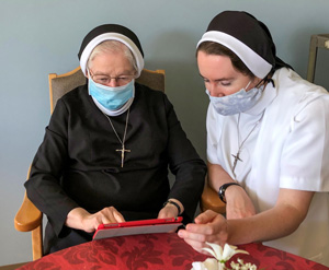 Two sisters using an iPad device