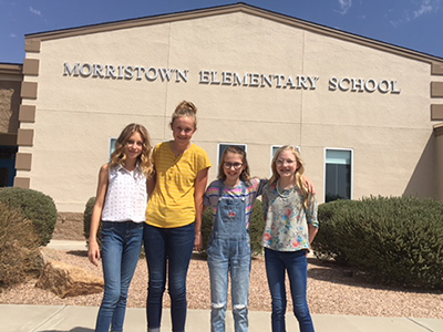 Student government officers pose together in front of Morristown Elementary School
