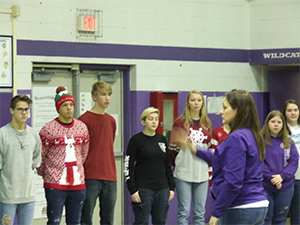 Close view of Show Cats performing for students with a conductor