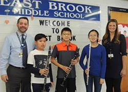 East Brook band members pose together with staff