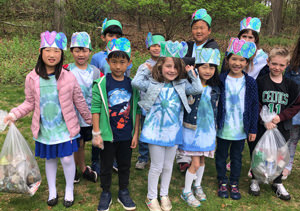 Group of students wearing I love earth hats