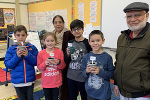 Students standing with two visiting grandparents