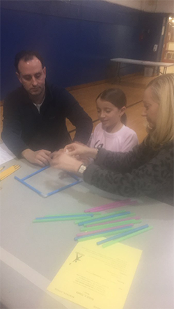 Parents help a student design a structure