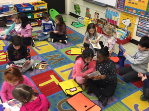 students in library reading together
