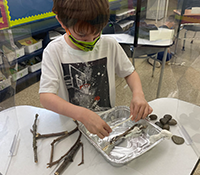 child working on beaver dam