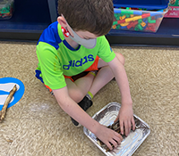 male child working on beaver dam