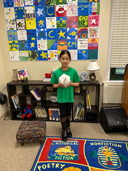 female student holding her project