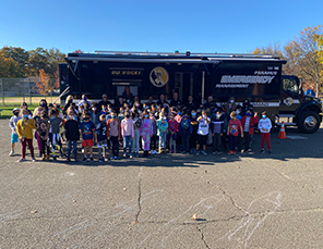 students standing in front of a bus