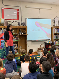 Anna Kang discusses her writing process using pictures in a presentation