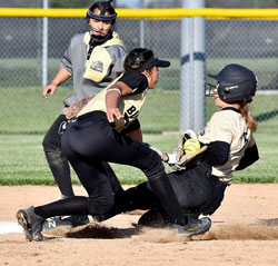 The softball starts to come out of Krystin Davis's mitt