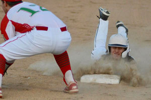 Madison-Grant's Chad Harbert dives safely into third base