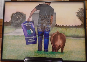 Person walking away poster in one hand and dog in other