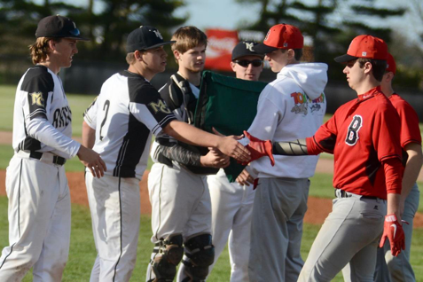 Madison-Grant’s (from left) Chad Harbert, Nick Evans, Mason Richards and Cole Hasty receive the traveling CIC home plate trophy from Blackford players after the Argylls’ 16-1 win over the Bruins Tuesday in Fairmount.