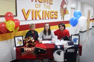 Makensie Rawlins with two staff members