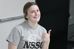 Female student smiling with thumbs up