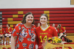 Senior volleyball athlete posing for a picture with her mother