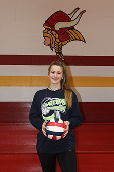 Female volleyball player holding a ball